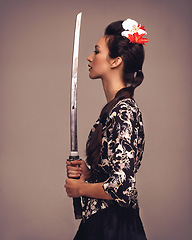 Image showing Asian woman, fashion and confident with sword in studio on brown background in traditional style and elegant. Japanese, female person and cultural with designer clothes or outfit for heritage