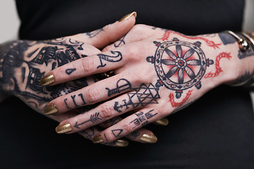Image showing Person, hands and tattoo with nails for polish, creative and ink for design, picture and symbol on closeup. Art, bold and cool for red and statement with varnish for funky, trendy and vibrant