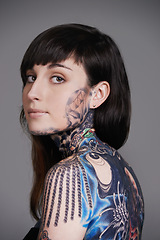 Image showing Woman, tattoo and portrait for creative, ink and design for picture and symbol for blue and colourful. Young person with art for bold, cool and statement for funky, trendy and unique for edgy