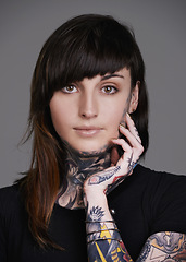 Image showing Woman, portrait and stylist with tattoo for facial treatment, style or body art on a gray studio background. Face of female person, young model or smile for design, creativity or cool beauty artist