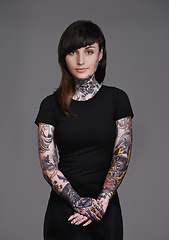 Image showing Woman, portrait and tattoo with fashion or sleeves for facial treatment, style or body art on a gray studio background. Female person, young model or smile in design, creativity or cool beauty artist