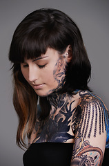 Image showing Calm woman, tattoo and fashion with body art for beauty, makeup or cosmetics on a gray studio background. Face of female person, young model or skin artist in relax with cool design or creativity