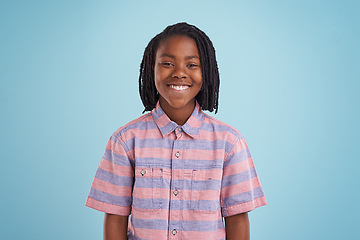 Image showing Boy, fashion and portrait of black child happy in studio with confidence, style or positive attitude on blue background. Face, smile or African teen model with good mood, clothes or outfit choice