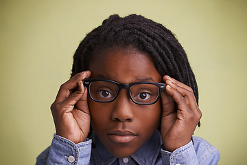 Image showing Glasses, vision and boy kid portrait in studio for eye care, wellness or optometry on green background. Frame, mockup or face of teen male model with eyesight, prescription or ophthalmology testing
