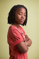 Image showing Fashion, children and portrait of black boy in studio with arms crossed in confidence on green background. Mockup, face and African teen model pose with attitude, style or cool outfit choice