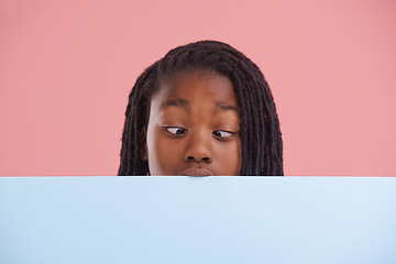 Image showing Poster, funny or boy child with cross eyes on mockup in studio for announcement, offer or info on pink background. Banner, comic or teen model with billboard presentation for silly, news or promo