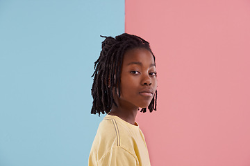 Image showing African teenager, portrait and fashion in studio with creative color, style and blue and pink background. Face of young and cool person, model or boy in natural hair and casual clothes with pastel