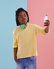Image showing Teen, boy and selfie of student in studio with headphones for listening to music in high school with fashion. Colorblock, mockup and post on social media with confidence and pride in profile picture