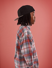 Image showing Boy, fashion or black child with cap in studio for confidence, style or streetwear aesthetic on red background. Face, profile or African teen male model with cool, clothes or trendy outfit choice