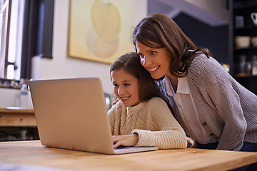 Image showing Mama, child and learning with laptop for support, care or browsing in the kitchen at home. Mother, daughter or kid typing on computer for social media, reading or helping girl on project or homework