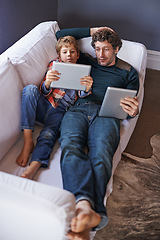 Image showing Father, son and tablet for gaming on sofa together, technology and online streaming for bonding at home. Digital world, internet and man with boy child in living room, gamer app and entertainment