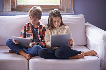 Image showing Young boy, girl and tablet for gaming on sofa together, technology and online streaming for bonding at home. Digital .world, internet with kids or siblings in living room, gamer app and entertainment