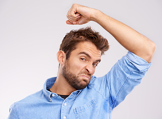 Image showing Man, smell armpit and bad hygiene, body odor with stink and sweat stain isolated on white background. Hyperhidrosis, poor hygiene and dirty, foul or negative with disgust for underarm in studio
