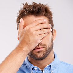 Image showing Regret, stress and face of man in studio with embarrassment, thinking and headache. Brain fog, shame and tired male person with anxiety, fatigue and bad memory on white background with hand on head