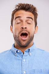 Image showing Man, eyes closed and yawn, tired in studio and burnout with facial expression and insomnia isolated on white background. Face, open mouth and fatigue with exhaustion, overworked and sleepless