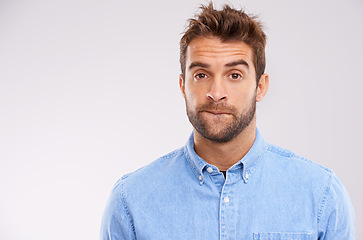 Image showing Studio, portrait and man with doubt, worry and confused on white background with mockup space. Opinion, disappointment and face of guy with decision, conflict or uncertainty for stress, news or ideas