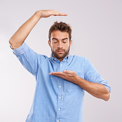 Image showing Box, size and man with hand gesture in studio with thinking, imagination or dream of growth. Eyes closed, relax and male person with product placement, invisible package and scale on white background