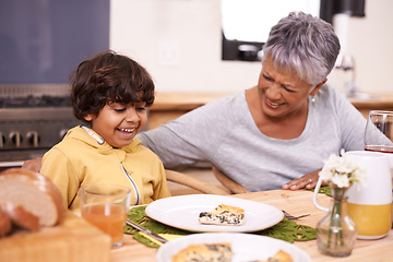 Image showing Happy grandmother, grandchild and food with family for thanksgiving, dinner or meal together at home. Grandma and little boy with smile at dining table in happiness for holiday weekend or bonding