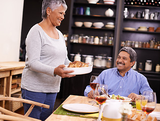 Image showing Senior, happy woman and family with turkey for thanksgiving dinner, meal or food at the table. Mature and hungry couple with smile for dining, eating or lunch in happiness together at the house