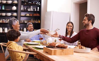 Image showing Happy, big family and sharing with food for thanksgiving dinner or passing meal at the table. Grandparents, parents and child with smile for dining, eating or lunch in happiness together at house