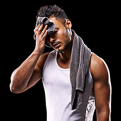 Image showing Fitness, sweat and man on black background with towel for exercise, training and intense workout. Bodybuilder, sports and serious person with muscles for performance, wellness and health in studio