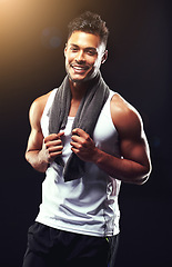 Image showing Fitness, portrait and happy man in studio with towel, confidence and workout for health, wellness and power. Smile, pride and strong athlete on black background for exercise, results and muscle