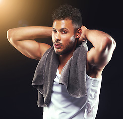 Image showing Fitness, towel and portrait of man on black background for exercise, training and intense workout. Bodybuilder, sports and serious person with muscles for performance, wellness and health in studio