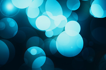 Image showing Bokeh, circle and blue sparkle wallpaper with lights for abstract pattern, design or texture of a background. Lens flare of color, lighting or blur bubbles of element, glitter or effect at night