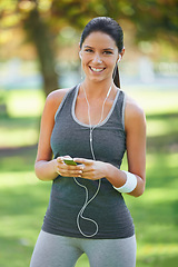 Image showing Woman, portrait and listening to music for exercise in park, fitness and commitment to training for healthy body. Young lady, happy face or runner with streaming audio for outdoor workout in nature