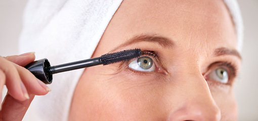 Image showing Makeup, mascara and face of woman with brush in studio for beauty, cosmetics or application. Eyelash, grey background or closeup of female model with eyelashes tool for volume, glamour or aesthetic