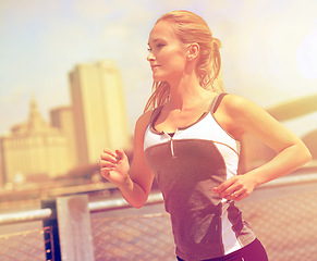 Image showing Woman, athlete and running for fitness and buildings, jog active and proud or happy female person exercising. New York city, energy and marathon for sport training or workout, cardio and wellness