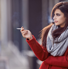 Image showing Woman, fashion and cigarette in city to think for stress relief or break as habit or daily routine for pressure escape in New York. Female person, nicotine outdoor and smoke tobacco, contemplating