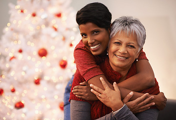 Image showing Elderly mother, daughter and hug on Christmas in portrait, happiness with gratitude and love to celebrate holiday. Trust, support and care with women at xmas party in the home, family and bonding