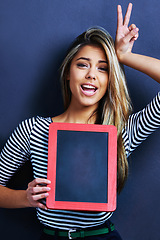 Image showing Woman, blackboard and space in studio portrait with peace sign, education promotion or mockup by blue background. Teacher, model or person with frame, board or emoji for feedback, vote or advertising