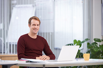 Image showing Portrait, smile and business man on laptop at desk in office for creative career in startup company. Face, employee or happy professional on computer at table, copywriter or entrepreneur in Australia