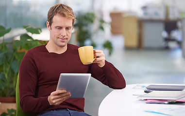 Image showing Tablet, drinking coffee and business man research in office for internet or reading email in startup. Technology, tea cup and professional on website, networking or creative designer on social media