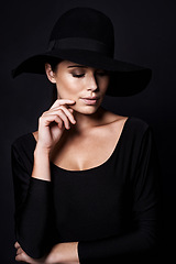 Image showing Woman, fashion and hat in studio with beauty, mob or classic gangster style on black background. Confidence, stylish with accessory and skin glow, fedora and vintage trend with designer clothes