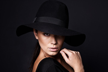 Image showing Woman, portrait and fashion hat with mystery beauty on black background with makeup cosmetics, confidence or stylish. Female person, studio and model or mockup space in America, glamour or formal