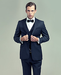 Image showing Man, studio and portrait with vintage, suit and fashion for class or luxury retro wealth. Gentleman, tuxedo and spy or agent with confidence, style and serious attitude isolated on white background