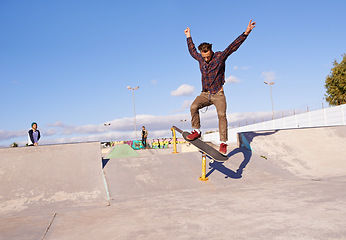 Image showing Fitness, freedom and man with skateboard, jump or rail balance at a skate park for stunt training. Energy, adrenaline and gen z male skater with air, sports or skill practice, exercise or performance