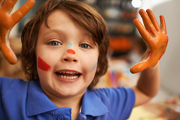 Image showing Happy boy, portrait and hands with face paint for artwork, craft or creativity at elementary school. Little male person, child or kid with smile for colorful art, youth or early childhood development