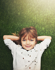 Image showing Happy, top view and portrait of child on grass for relaxing, playful fun and happiness in garden. Family, nature and above of young girl for childhood, playing and freedom on weekend outdoors