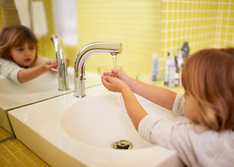 Image showing Girl, bathroom and hands with washing, hygiene and cleaning with mirror at home. Child, faucet and reflection for healthy, development and childhood with morning routine at house for cleanliness