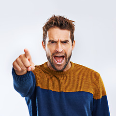 Image showing Angry man, portrait and pointing to you with shout for choice, pick or frustration on a gray studio background. Frustrated male person or model yelling or screaming with mood or attitude on mockup