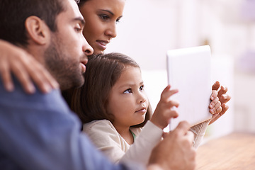 Image showing Home, family and parents with girl, tablet and playing online games with connection and bonding together. Apartment, mother or father with daughter and technology with digital app, movies or internet