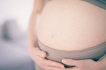 Image showing Pregnant woman belly. Pregnancy Concept. Pregnant tummy close up. Detail of pregnant woman relaxed at home.