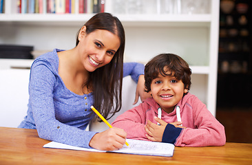 Image showing Mother, child and portrait with book for homework, help and education for learning, study and development. Indian people, mom and boy with smile and pencil for teach, writing and grades in house