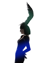 Image showing Feather, fashion and unique style woman in a studio with head piece, bird hat and art with gothic creativity. Crow, silhouette and shadow with fantasy and with goth trend and white background