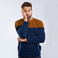 Image showing Frustrated man, portrait and bored with headache in stress, depression or anxiety on a studio background. Young, tired or upset male person with mood, disappointed or mental health on mockup space