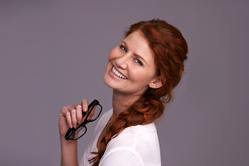 Image showing Young woman, portrait and excited in studio with glasses for optometry choice, frame and confidence. Happy face of a young person or model happy for specs, eyewear or vision care on a gray background